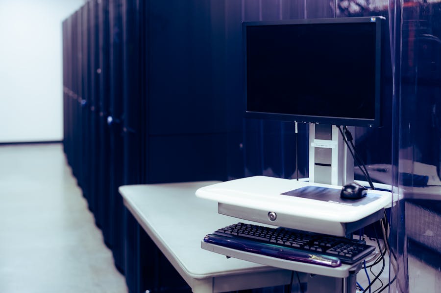 Server rack aisle with a workstation in a datacenter