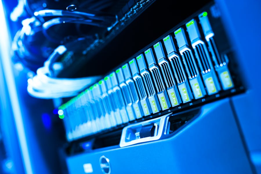 Close-up of illuminated storage drives in a server rack