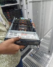 Server hardware being handled in front of an open datacenter rack